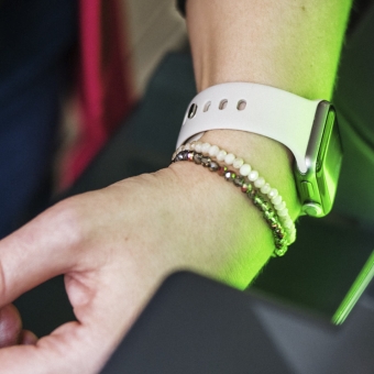 Eine Frau zahlt mit Ihrer Uhr.